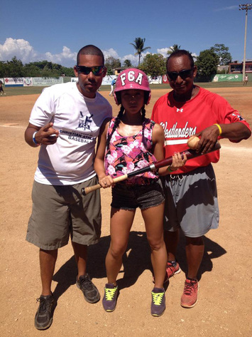 Trainers Luís Hernández and Pichi Capsula with female softball player at Club Juan Alberto Ozoria in Boca Chica, Dominican Republic